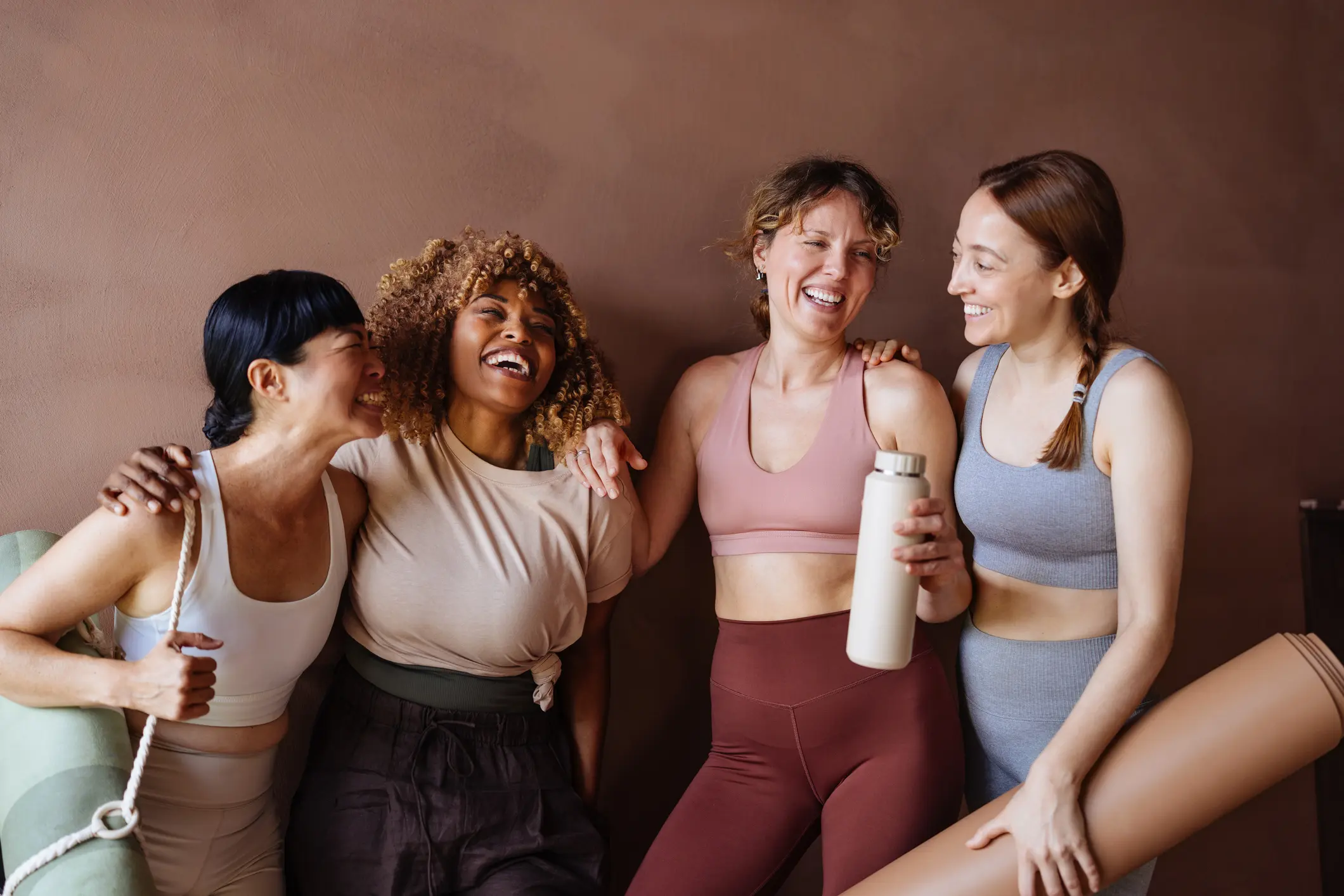 Women with yoga mats and water bottle